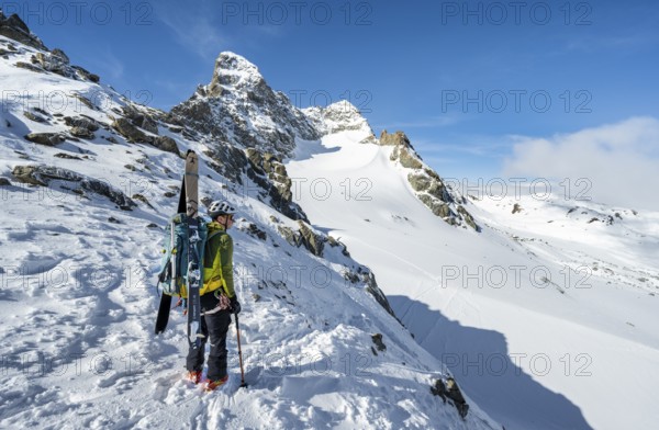 Mountaineer with skis at the fork Porta d'Es-cha, view of mountain peak Piz Kesch and glacier Vadret da Porchabella, ski tour Bündner Haute Route, Albula Alps, Rhaetian Alps, Grisons, Eastern Switzerland, Switzerland, Europe