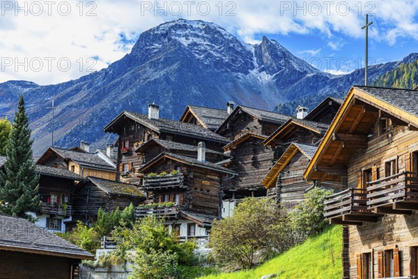 Old wooden houses in the historic village centre, behind the summit of the Scex Marenda mountain, Grimentz, Val d'Anniviers, Valais Alps, Canton Valais, Switzerland, Europe