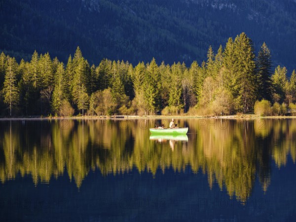 Angler in a rowing boat on the Hintersee in the first sunlight, Berchtesgaden National Park, Ramsau, Berchtesgadener Land, Upper Bavaria, Bavaria, Germany, Europe