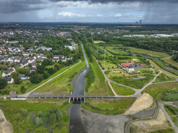 Dortmund / Castrop-Rauxel, North Rhine-Westphalia, Germany, river renaturalisation, renaturation of the Emscher, flood retention basin HRB Mengede. A new floodplain landscape is being created at the Emscher-Auen farm, expanding the area for flood protection during heavy rainfall and for biodiversity. The Emscher, which is currently straightened, will be given curves again and can meander through its new floodplain. Following the construction of a parallel sewer, the Emscher has been completely free of wastewater since 2022. The river was previously an open, above-ground mixed water channel with rainwater and wastewater. At the back right, the Uniper coal-fired power plant Datteln 4 power station, Europe