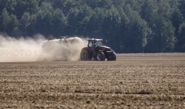 Upper Lusatia, Saxony, Germany - Dust-dry fields in a hot summer, a tractor working the field, spreading liquid manure directly into the soil