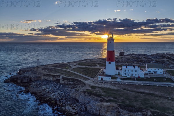 Sunset over Portland Bill Lighthouse from a drone, Portland Bill, Isle of Portland, Dorset, England, United Kingdom, Europe
