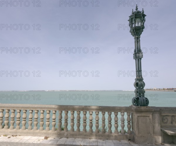 View over the bay of Cadiz with lamppost from the garden Jardines Clara Campoamor, Cádiz, Spain, Europe