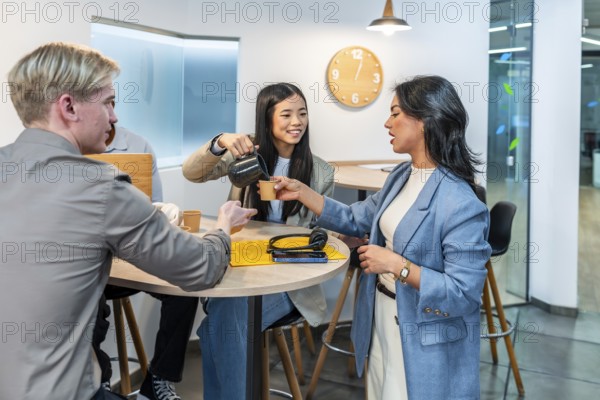 Businesswomen and businessmen enjoying a coffee break in a modern coworking office, fostering teamwork and collaboration