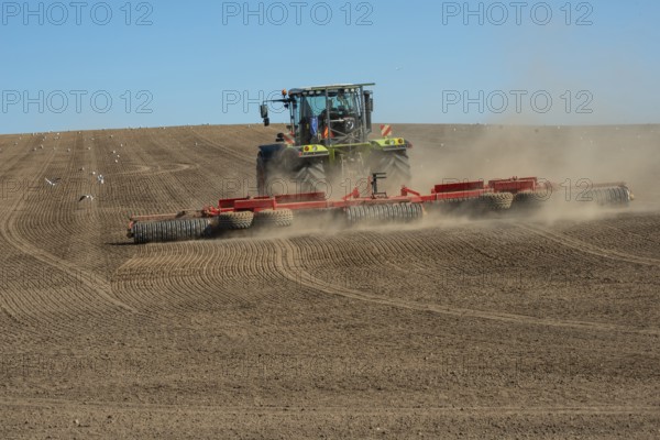 Tractor with rollers preparing the ground for spring sowing at Krageholm, Ystad Municipality, Skåne County, Sweden, Scandinavia, Europe