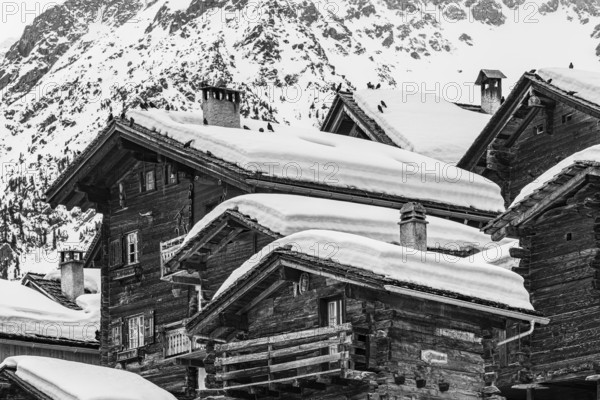 Old snow-covered wooden houses in the historic village centre, black and white photograph, Grimentz, Val d'Anniviers, Valais Alps, Canton Valais, Switzerland, Europe
