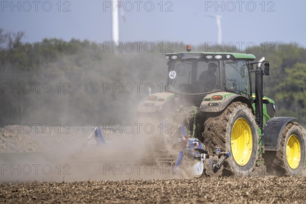 A tractor works a field, due to long dryness in spring, no rain for more than 4 weeks, the fields are dusty, south of Straelen, Lower Rhine, North Rhine-Westphalia, Germany, Europe