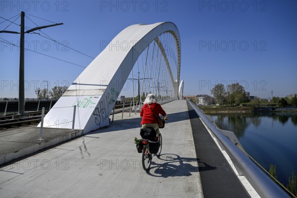 Cyclist on the Beatus-Rhenanus-Bridge, tram bridge over the Rhine, Kehl, Ortenaukreis, Baden-Württemberg, Germany, Europe