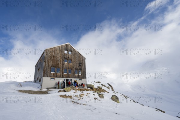 Chamanna Es-cha mountain hut in a cloudy winter mountain landscape, Bündner Haute Route ski tour, Albula Alps, Rhaetian Alps, Grisons, Eastern Switzerland, Switzerland, Europe