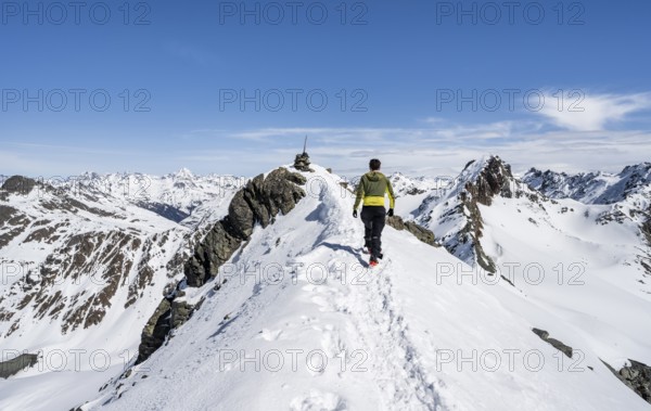 Mountaineer on the summit of the Scalettahorn in winter, Graubünden Haute Route, Albula Alps, Rhaetian Alps, Graubünden, Switzerland, Europe