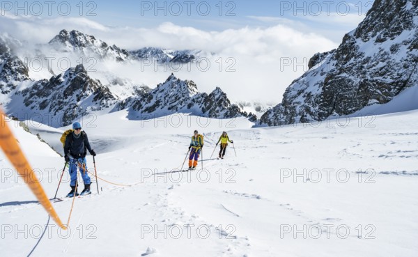 Ski tourer with rope, rope team on the Vadret da Porchabella glacier on the ascent to the summit of Piz Kesch, mountain landscape in winter, alpine tour, ski tour Bündner Haute Route, Albula Alps, Rhaetian Alps, Grisons, Eastern Switzerland, Switzerland, Europe