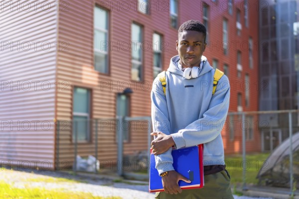 Urban african american student standing proud looking at camera outside the university