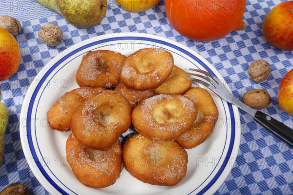 Swabian cuisine, harvest cakes, dessert, dessert, fat baked goods, doughnuts, fried food, lard noodles, arranged on a plate, grandmother's kitchen, regional, home cooking, typical Swabian, classic recipe, traditional cuisine, food photography, autumn atmosphere, apples, pears, nuts, still life, studio, Germany, Europe