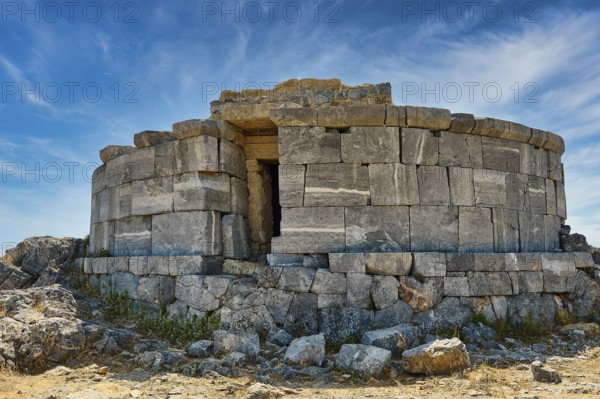 Ancient stone tower in ruins, surrounded by large rocks and blue sky, tomb of Cleovoulos the Lindian, ruins, near Lindos, Lindos, Rhodes, Dodecanese, Greek Islands, Greece, Europe