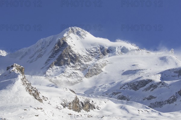 Snow covered mountaintop, pinnacle of the Gran Paradiso mountain in winter in the Gran Paradiso Massif of the Graian Alps, Aosta Valley, Italy, Europe