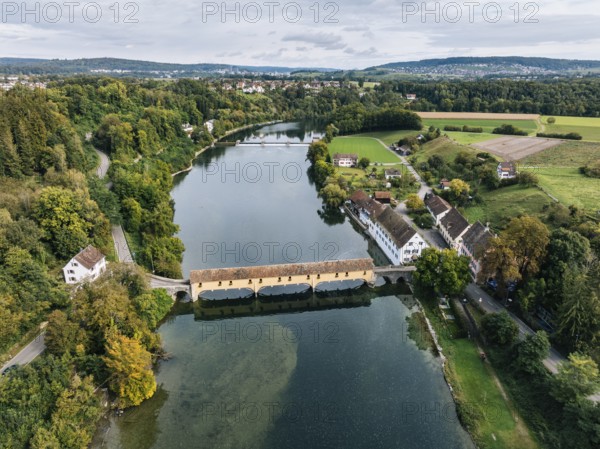 Aerial view of the covered Rhine bridge connecting the Swiss municipality of Rheinau and the German municipality of Altenburg. The bridge is one of the now rare Pfahljoch bridges in the canton of Zurich, Switzerland, Europe