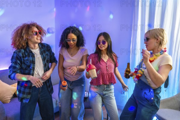 Four friends are singing karaoke and dancing together at a house party, enjoying music, drinks, and colorful lighting