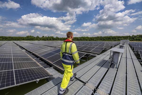Germany's largest floating solar power plant on the Silbersee III, a quarry pond no longer used for sand mining, near Haltern am See, operated by Quarzwerke GmbH, around 5800 solar modules, on an area of a good 2 football pitches, generate 3.1 megawatts of power, the company uses the electricity itself on weekdays, at weekends it flows into the public grid, North Rhine-Westphalia, Germany, Europe