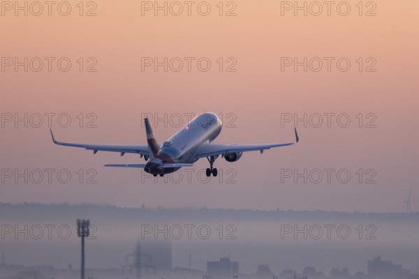 Passenger aircraft after take-off, in front of sunrise, fog, Baden-Württemberg, Germany, Europe