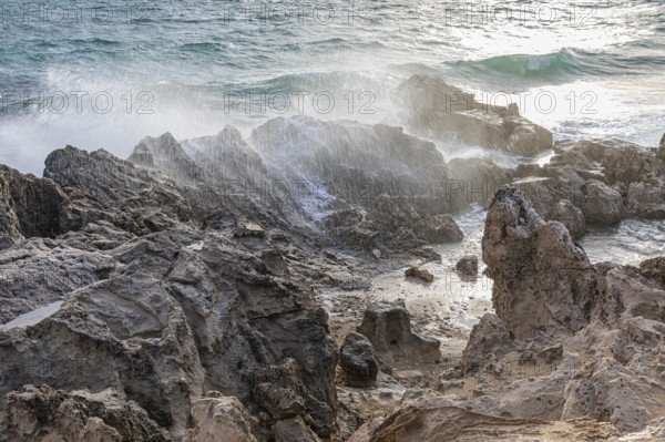 Sea water lashes over the eroded rocks on Salines beach, Ibiza, Balearic Islands, Mediterranean Sea, Spain, Europe