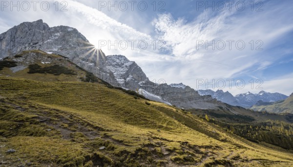 Mountain landscape with yellow meadows in autumn, summit Lamsenspitze with sun star, Karwendel, Tyrol, Austria, Europe