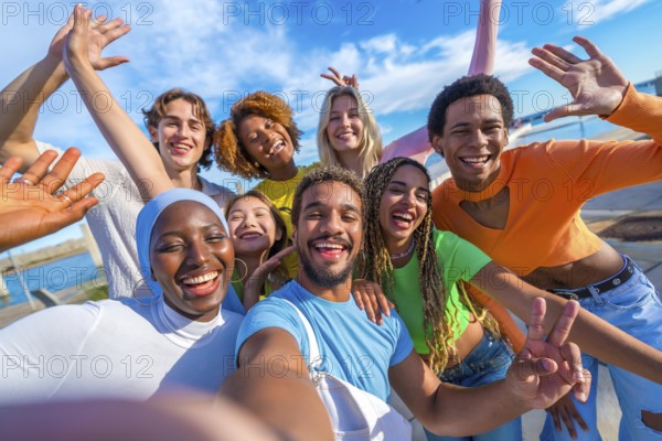 Large group of multi-ethnic happy young people taking a selfie in the city