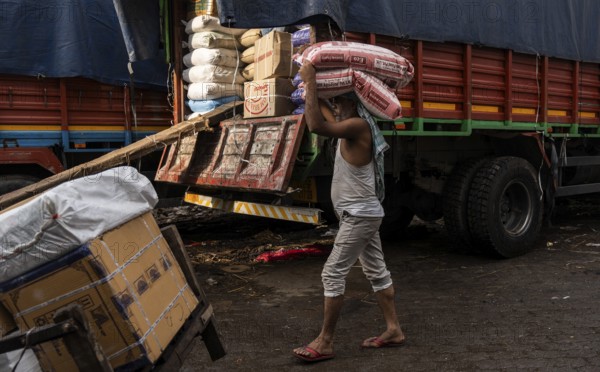 GUWAHATI, INDIA - MAY 1: Labourers carries goods in a wholesale market, in Guwahati, India, on May 1, 2025. May Day or Workers Day is a global holiday celebrated on May 1st to honor workers and their contributions, Asia