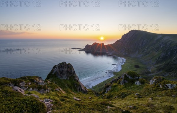 View of coastal landscape at sunset, cliffs and summit of Måtind or Måtinden, Høyvika beach and sea, Andøya island, Vesterålen, Nordland Norway