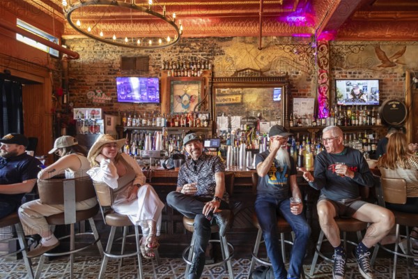 New Orleans, Louisiana - People at the bar drink and listen to music at Bamboula's music club on Frenchmen Street in the Marigny neighborhood