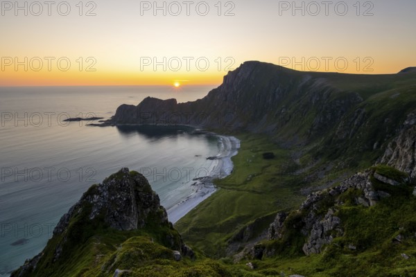 View of coastal landscape at sunset, cliffs and summit of Måtind or Måtinden, Høyvika beach and sea, Andøya island, Vesterålen, Nordland Norway