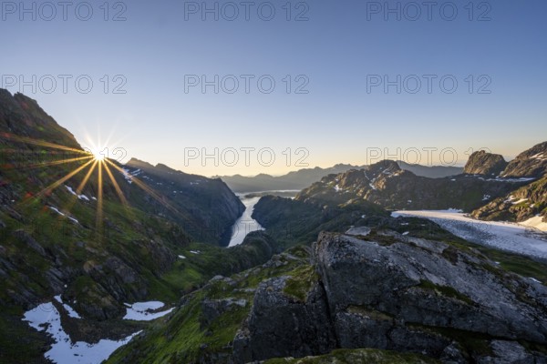Picturesque mountain landscape at sunrise with sun star, fjord Trollfjord and Raftsund, hike to Trollfjord Hytta, Lofoten, Nordland, Norway, Europe