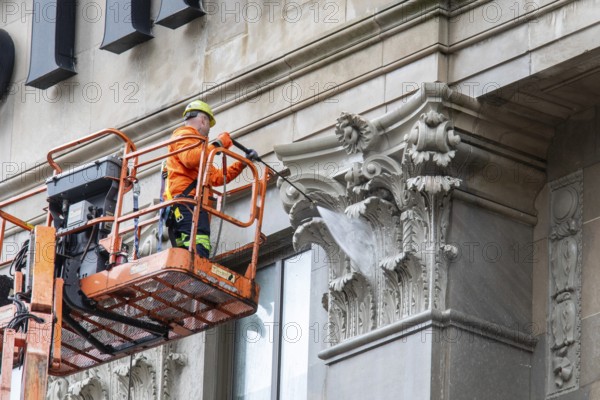 Detroit, Michigan - A worker uses a high-pressure water spray to clean the exterior of the 100-year-old Westin Book Cadillac Hotel