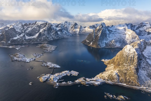 View of islands, fjord and mountains, snow-covered landscapeFishing villages Hamnøy, Sakrisøy and Reine, Reinefjord, Lofoten, Norway, Europe