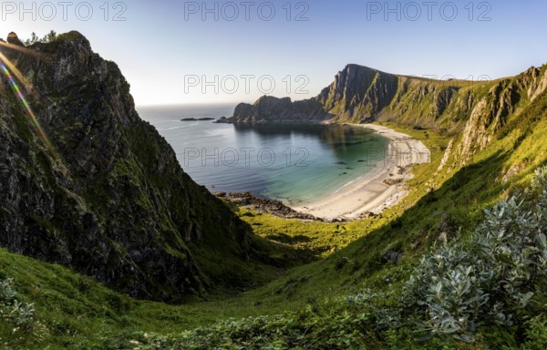 View of coastal landscape, steep coast with peak Måtind, Høyvika beach and sea in the evening light, hike to the peak of Måtind, Andøya island, Vesterålen, Nordland Norway