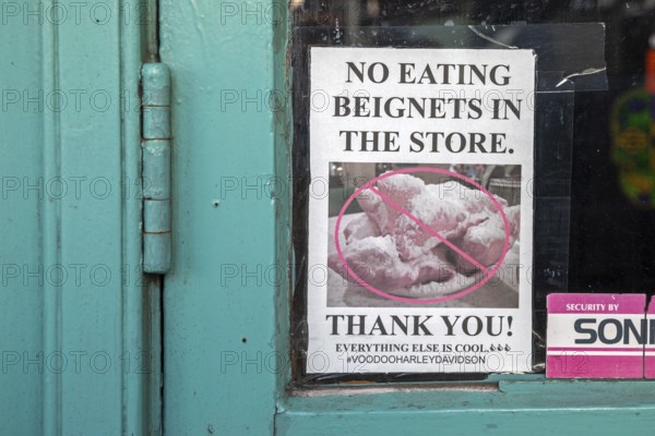 New Orleans, Louisiana - A sign in a store in the French Market asks visitors not to eat beignets in the store. The neighboring Cafe du Monde sells those pastries, which are loaded with powdered sugar and tend to be messy
