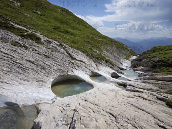 Glacier mill with glacier pots on the Trinser Alp Mora, Trin, Canton Graubünden, Switzerland, Europe