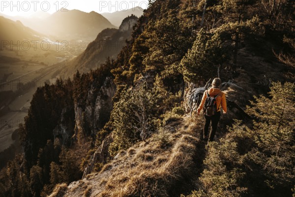 Hiker in the Allgäu at sunset in spring on the Zirmgrat near Pronten in the Allgäu