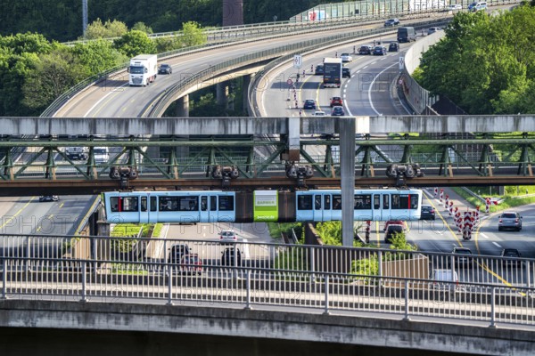 The Wuppertal suspension railway, train of the latest generation 15, crosses the A46 motorway, Sonnborner Kreuz, North Rhine-Westphalia, Germany, Europe