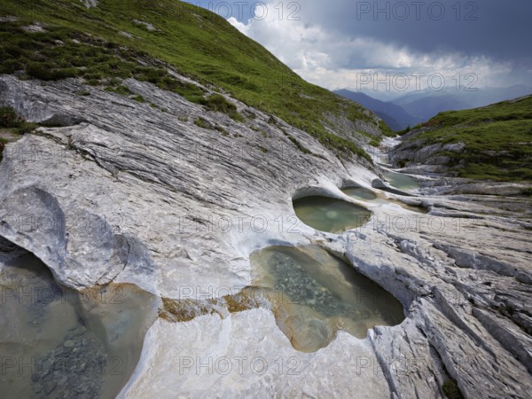 Glacier mill with glacier pots on the Trinser Alp Mora, Trin, Canton Graubünden, Switzerland, Europe