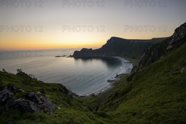 View of coastal landscape at sunset, cliffs and summit of Måtind or Måtinden, Høyvika beach and sea, Andøya island, Vesterålen, Nordland Norway
