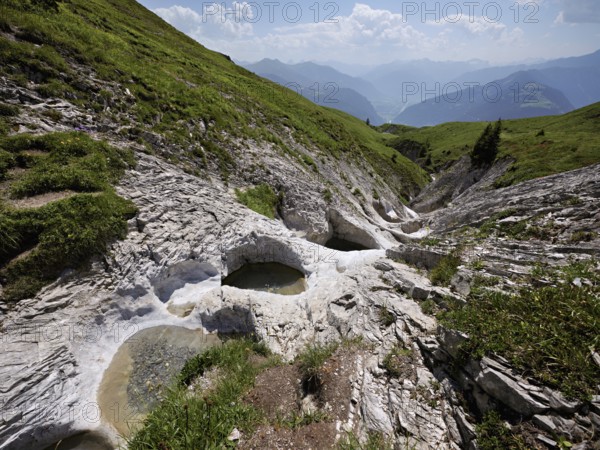 Glacier mill with glacier pots on the Trinser Alp Mora, Trin, Canton Graubünden, Switzerland, Europe
