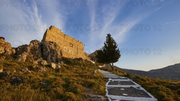 Warm evening light, path to a ruin with tree under blue sky and clouds, Archangelos, castle, place, Castle of Archangelos, Rhodes, Dodecanese, Greek Islands, Greece, Europe