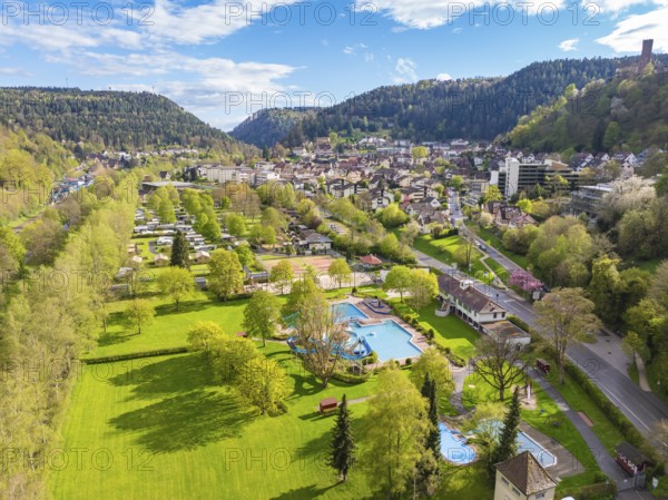 Green parkland with pool and town in a mountainous setting, Bad Liebenzell, Calw district, Black Forest, Germany, Europe