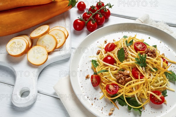 Yellow zucchini salad, with cherry, vegetarian food, sliced into strips, homemade