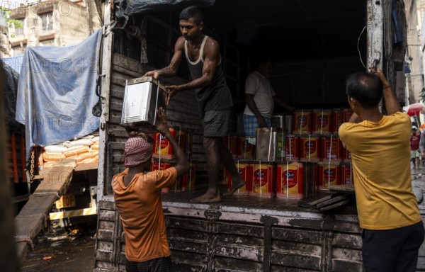 GUWAHATI, INDIA - MAY 1: Labourers carries goods in a wholesale market, in Guwahati, India, on May 1, 2025. May Day or Workers Day is a global holiday celebrated on May 1st to honor workers and their contributions, Asia