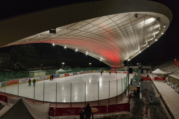 Tourists on ice rink, ice sports stadium, ice skating in the evening, Schierker Feuerstein Arena, Graft Architekten, Schierke, Wernigerode, Harz National Park, Saxony-Anhalt, Germany, Europe