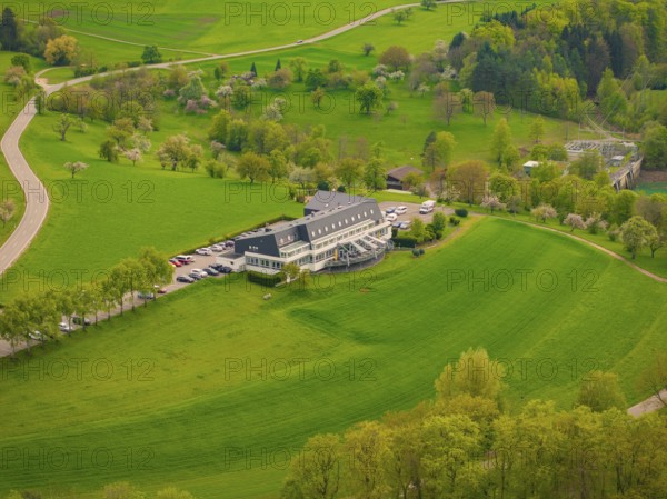 Hotel Large building on green meadows with surrounding trees and roads in the landscape, Glems reservoir, Swabian Alb, Germany, Europe