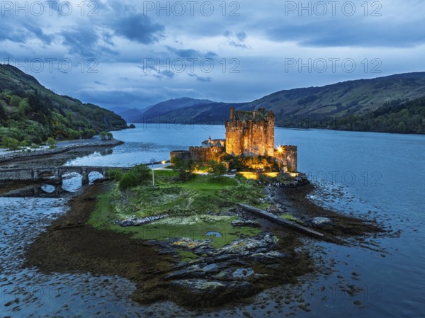 Night over Eilean Donan Castle and Loch Duich from a drone, Isle of Skye, Highlands, Scotland, England, United Kingdom, Europe