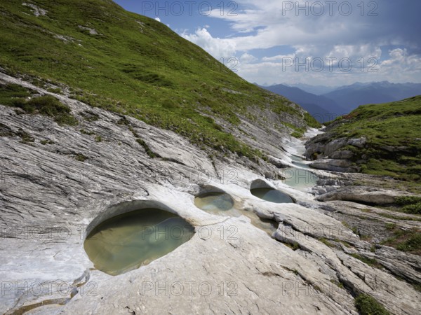Glacier mill with glacier pots on the Trinser Alp Mora, Trin, Canton Graubünden, Switzerland, Europe