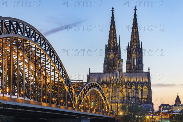 Cologne Cathedral, illuminated in the evening. Hohenzollern Bridge, railway bridge over the Rhine. City view of Cologne, North Rhine-Westphalia, Germany, Europe